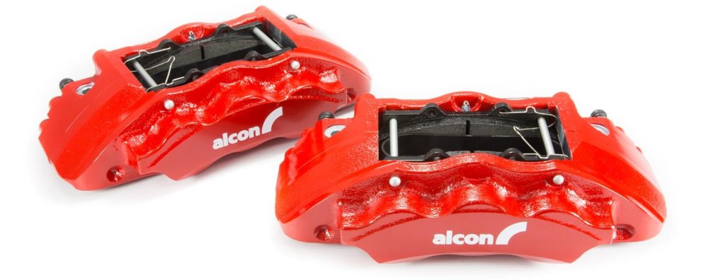 a pair of alcon opposed piston calipers in a red finish
