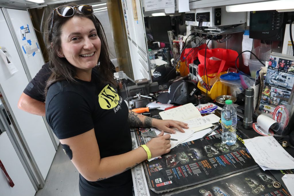 racer signing autograph in a trailer