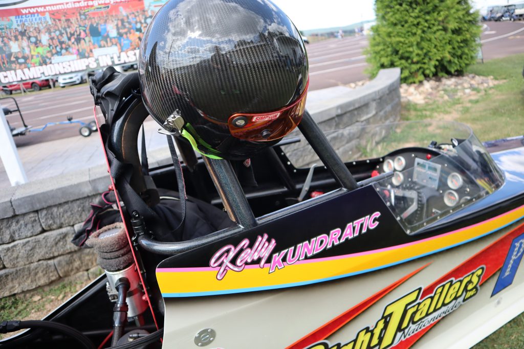 racing helmet resting atop a dragster