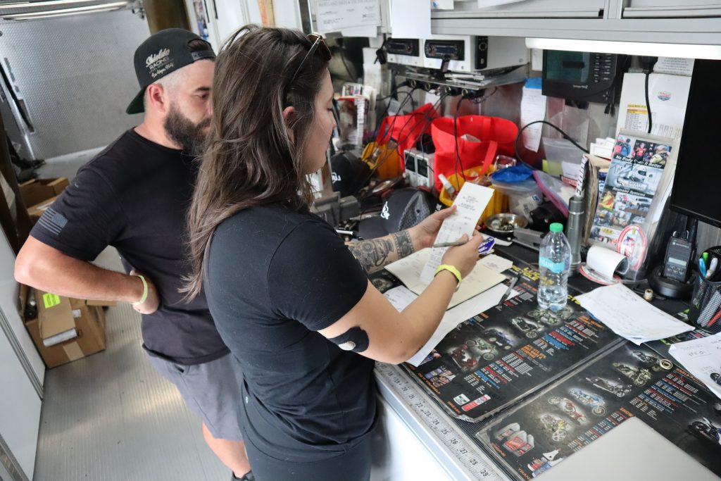 racer reviewing a timeslip in a trailer