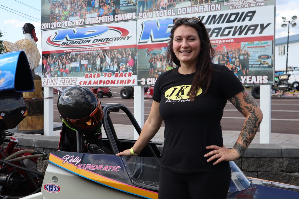 Kelly Kundratic poses next to her dragster