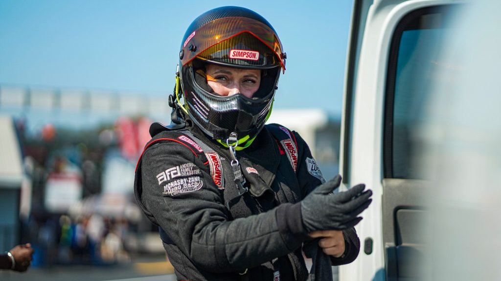 Race car driver in racing suit and helmet