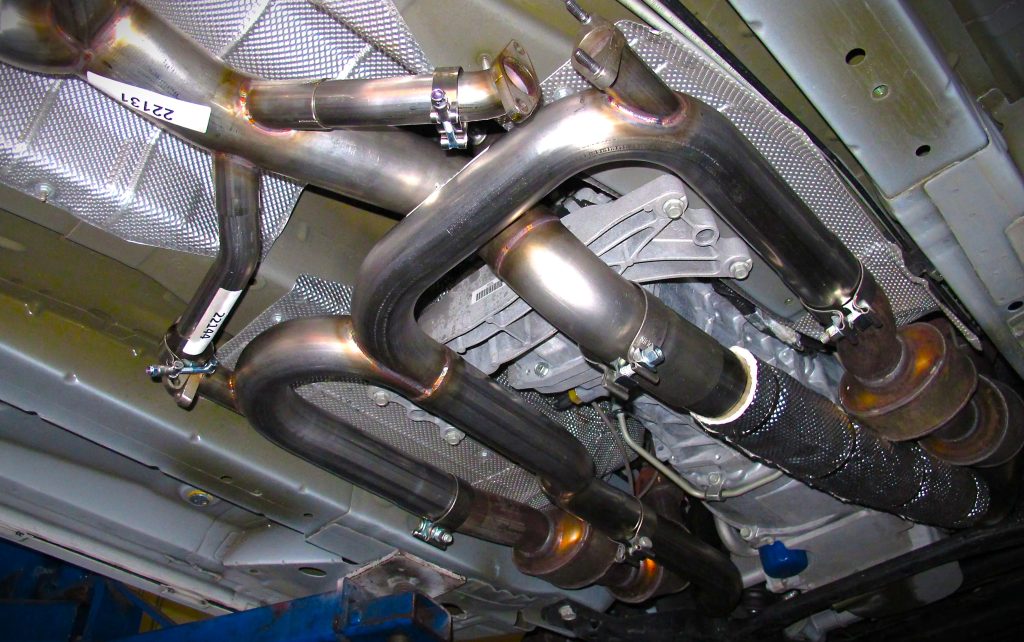 collection of exhaust pipes under a vehicle
