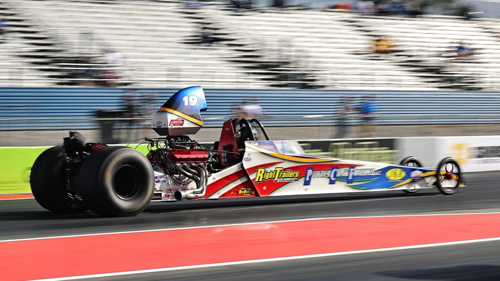 dragster running down racetrack