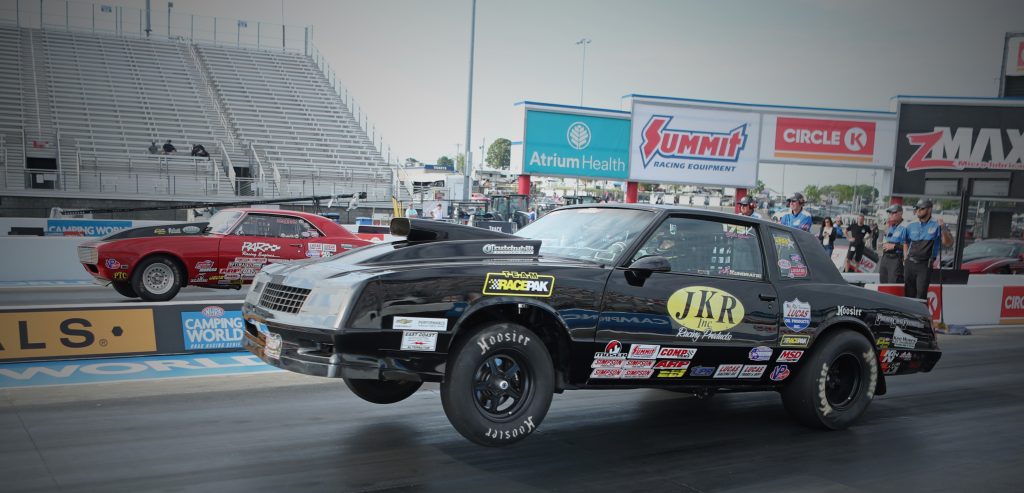 a camaro and monte carlo SS launching at dragstrip
