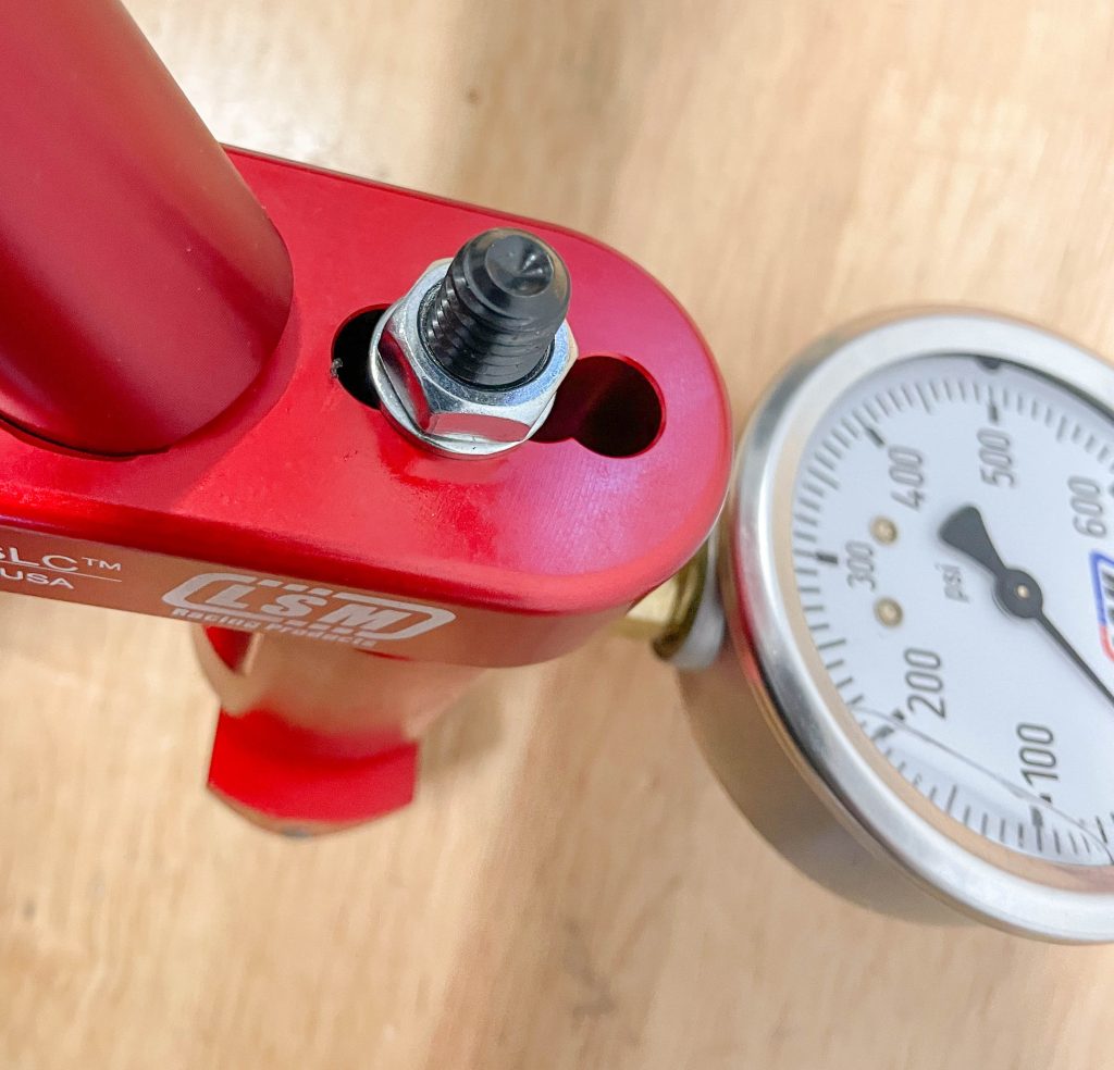 Adjusting load rollers on LSM valve seat spring pressure tool