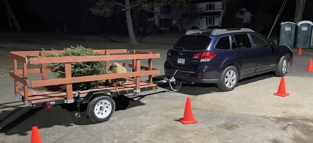 subaru outback pulling a tree on a trailer
