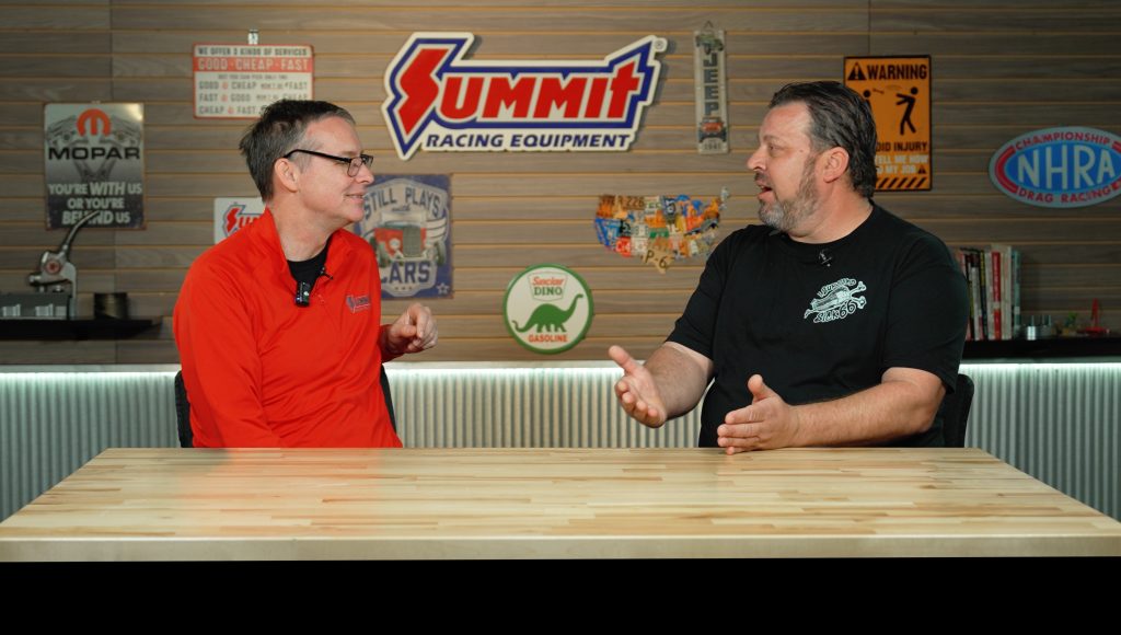 two men talking at a table during interview