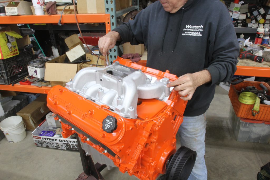 man assembling a gm ls engine