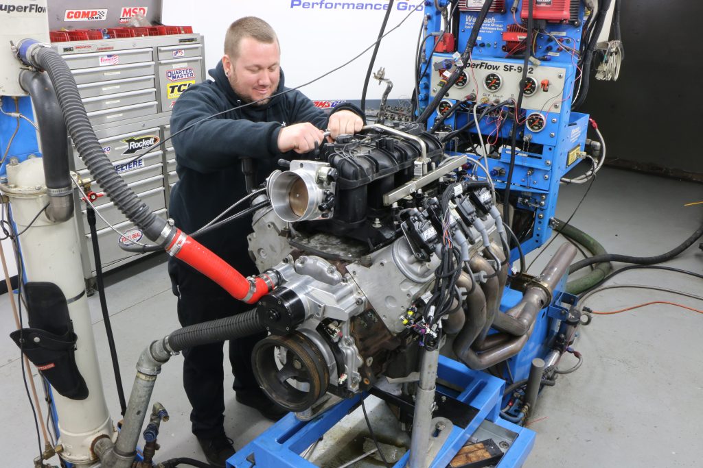 man installing an intake on a 6.0L LS Engine