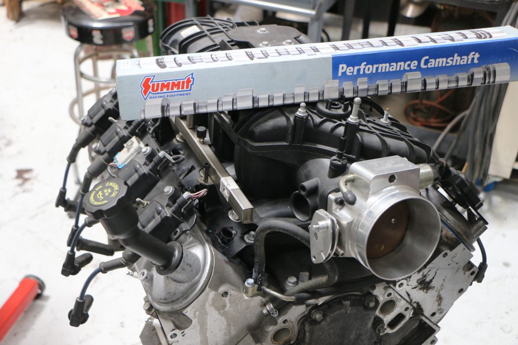 Camshaft box resting atop and engine