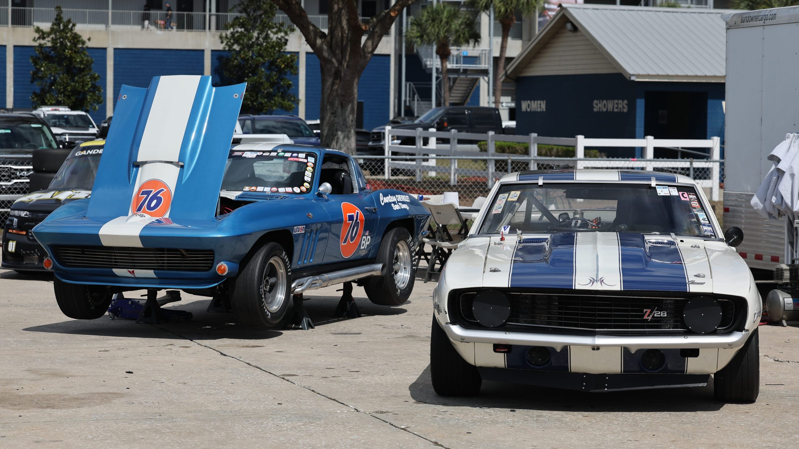 C2 Corvette Sting Ray and Camaro Z/28 race cars in paddock