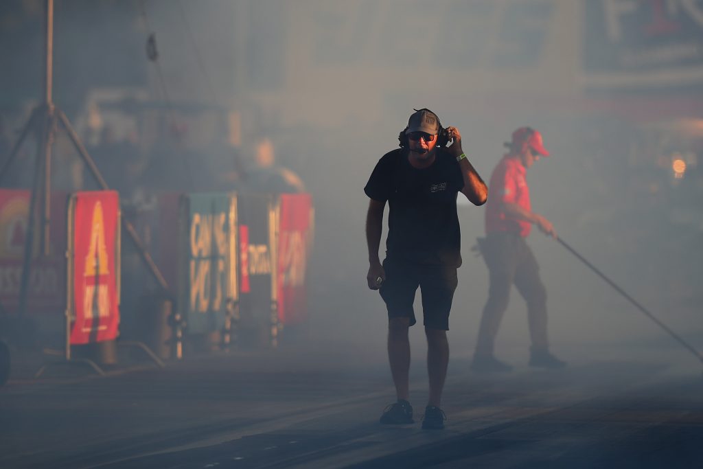 man in headset on dragstrip track
