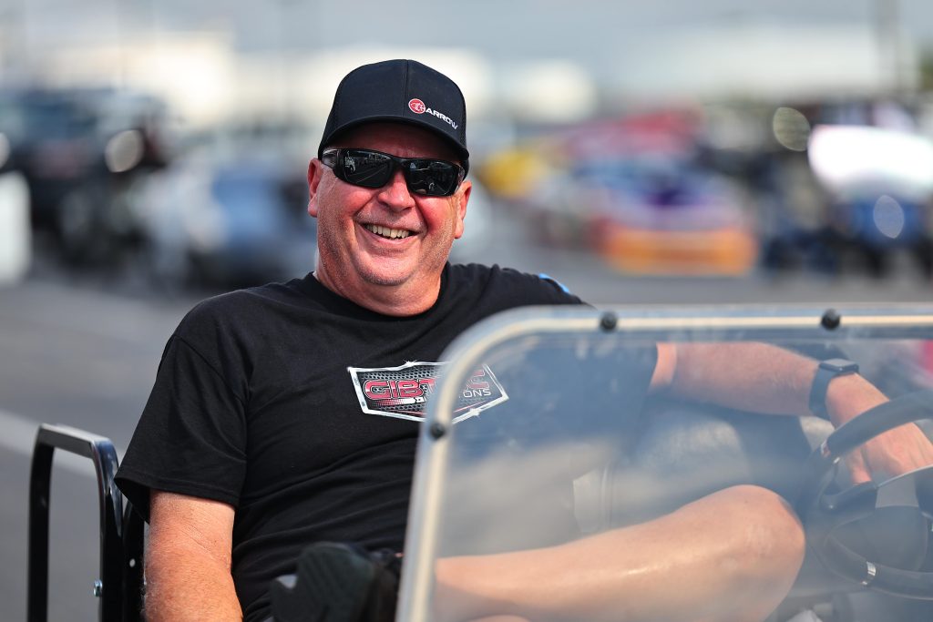 man smiling in golf cart