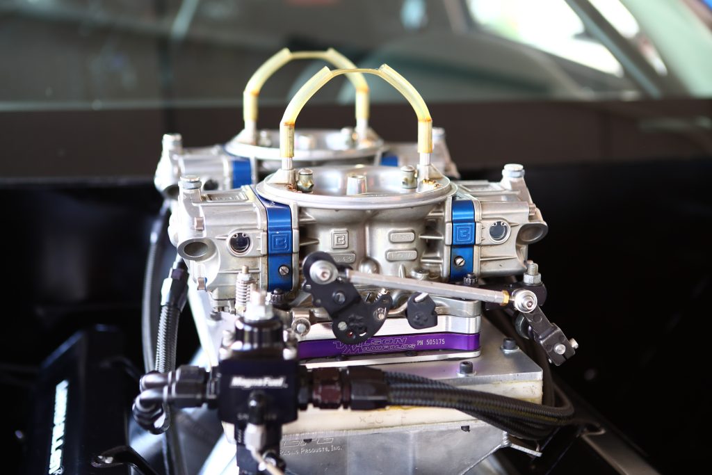 a pair of carburetors on a race engine