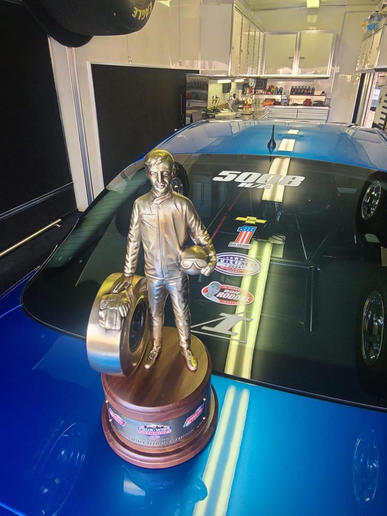 wally trophy resting on deck of a drag car