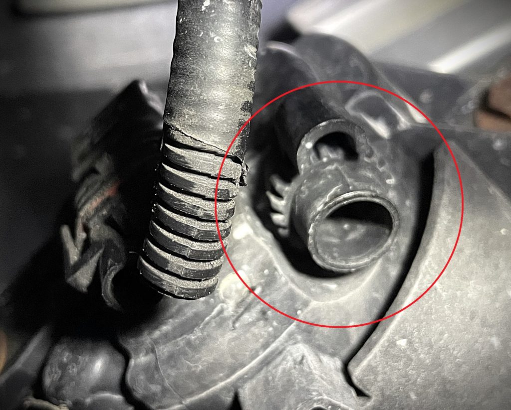 close up of a geared adjustment wheel on a headlight housing