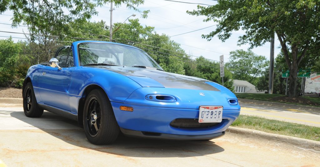 Blue NA Miata in a Parking Lot