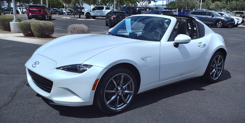 white ND Mazda Miata in parking Lot