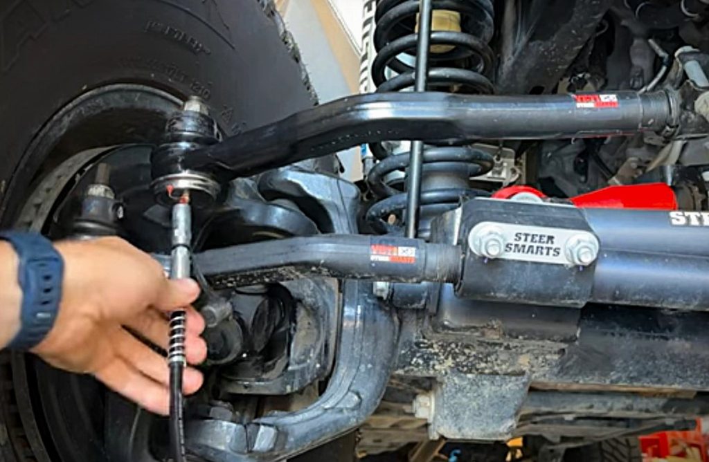 putting a grease gun on a zerk fitting