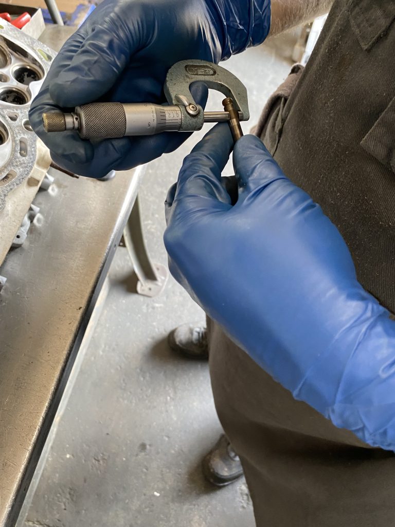 measuring valve stem diameter with a micrometer
