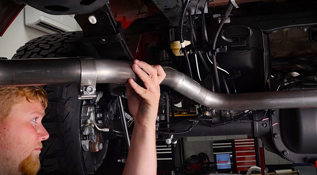man fitting together exhaust tubing sections