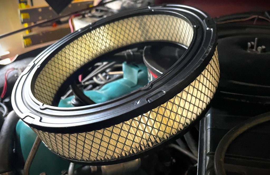 paper air filter resting atop and engine 3