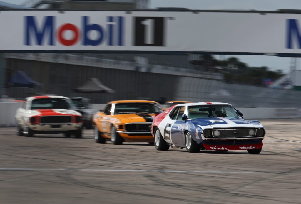 a group of vintage trans am race cars entering a corner