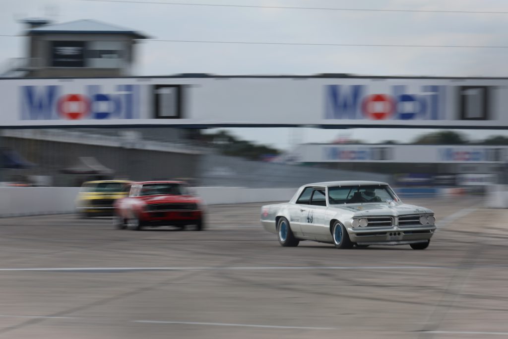 A group of vintage musclecars on a race track