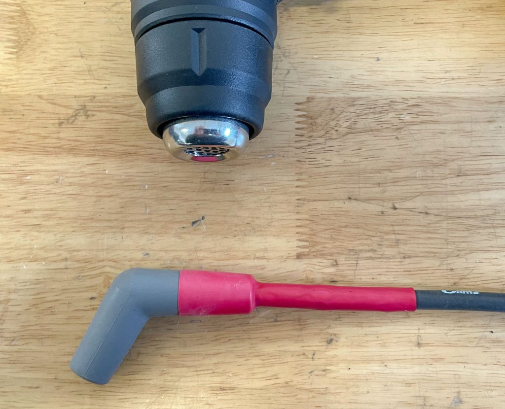 Applying heat sleeve on ignition wire