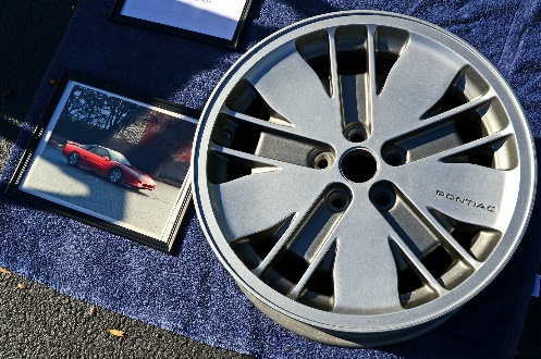 car wheel resting on driveway next to photograph