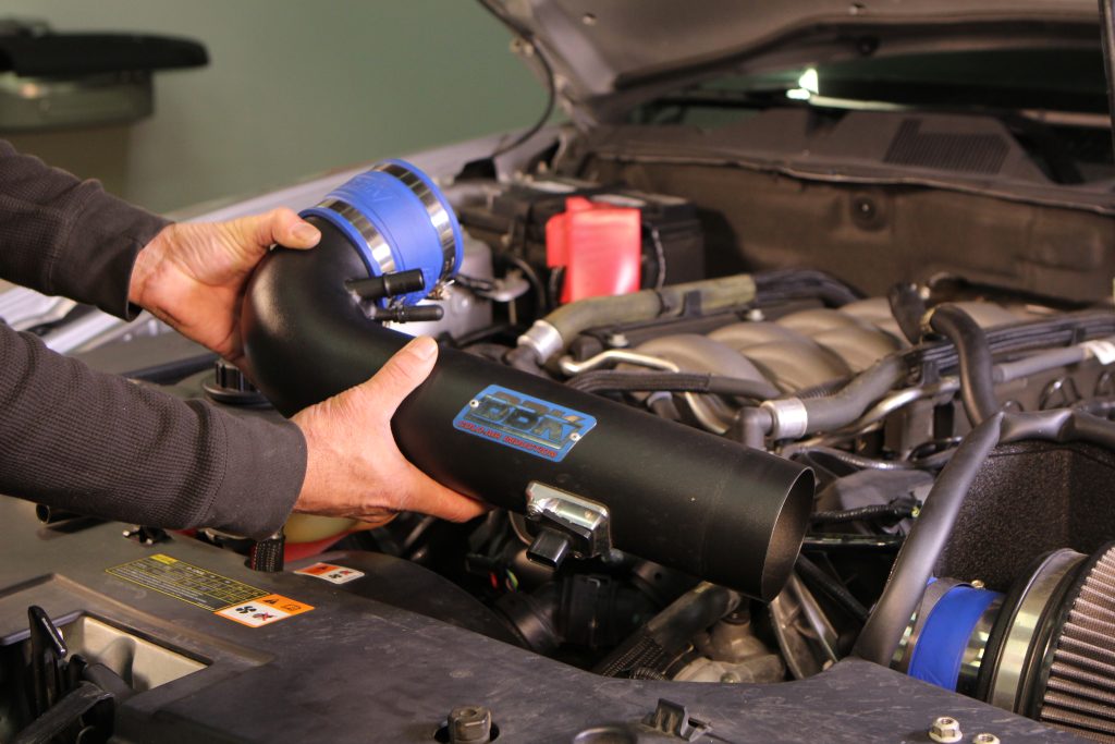 Man holding BBK Air intake tube section