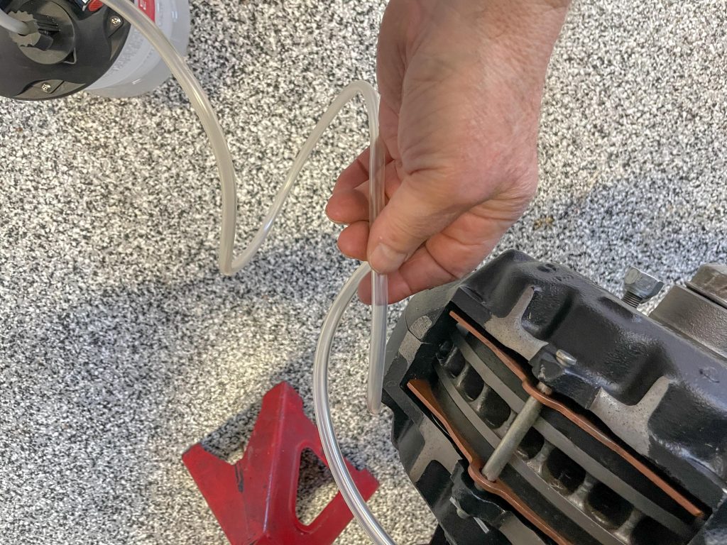 Removing brake fluid from disc brake caliper