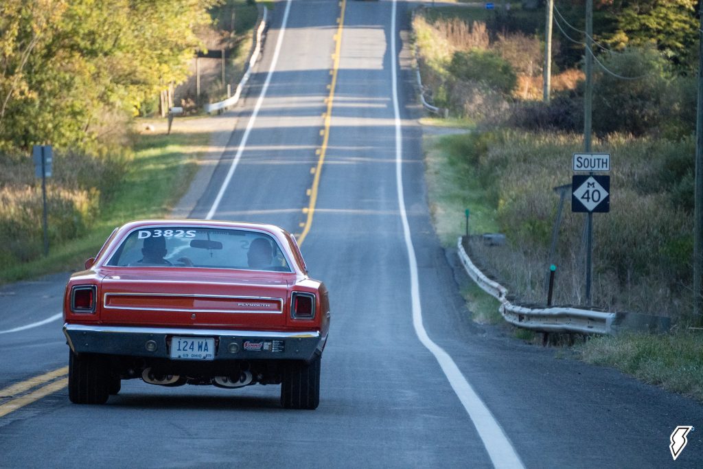 rear view of a 1969 Plymouth Satellite driving down a road