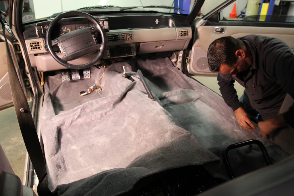 installing new carpet into a car