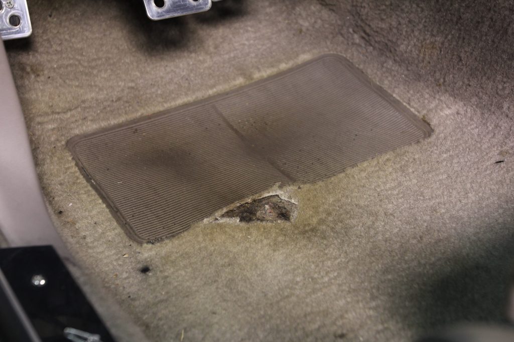 old, ragged carpet in a car