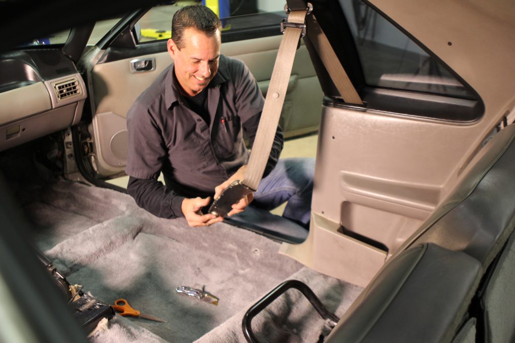 installing seatbelt bracket into a car