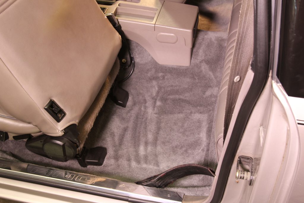 back set of a car with new carpet