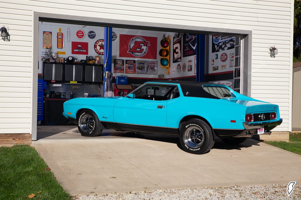 1973 Ford Mustang Grande in front of a garage