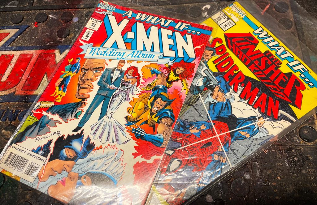 a pair of what if Marvel Comic books on table